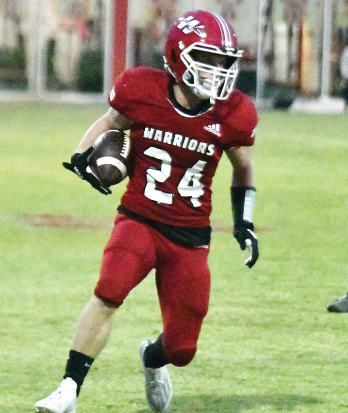 Washington sophomore Hudson Howard carries the ball Friday night during the Warriors&rsquo; 39-0 win over Crooked Oak last Friday. Washington travels to Lindsay tonight (Thursday).