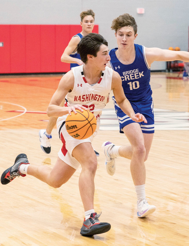 Washington sophomore Mason Adams drives to the hoop Friday during the Warriors&rsquo; 52-46 win over Bridge Creek. Adams scored a team-high 14 points.