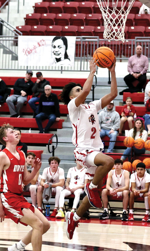 Purcell sophomore Kobe Freeman soars toward the goal for two of his game-high 14 points in the Dragons&rsquo; 51-19 win over Davis.