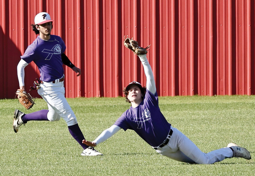 Purcell junior Jett Tyler lays out for a ball in center field during Purcell&rsquo;s game with Newcastle. The Dragons were defeated 10-6.