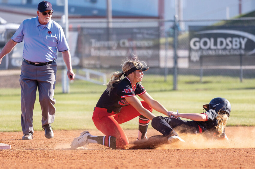 Washington senior Skylar Wells tags out a Westmoore base runner last Thursday during the Warriors&rsquo; 11-4 win over Class 6A No. 7 Westmoore.