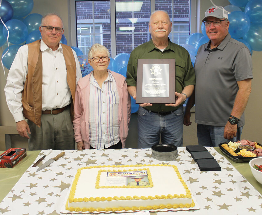 When Jim Tyler hung up his badge and weapon, he was honored with a retirement reception at the McClain County Courthouse. Among those on hand for the event, from left, were Sheriff Landy Offolter, Ruth Tyler, Jim and former Sheriff Don Hewett.