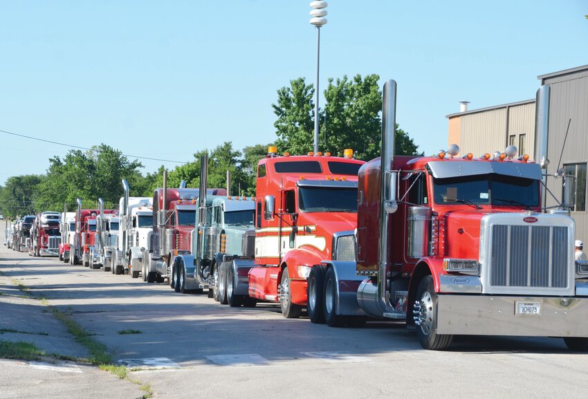 At least 18 big rig operators came to Purcell Friday to pay tribute to their fellow trucker Randy Rolin who was laid to rest after being killed in a Texas tornado June 21. The trucks lined up on Lester Lane and were front-to-back stretching for three blocks.