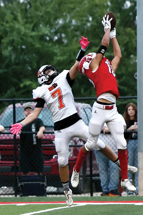 Purcell sophomore Oscar Wren climbs the ladder as he hauls in a 41-yard touchdown pass from Kash Guthmueller Friday night against Lexington. The Dragons defeated the Bulldogs 56-0.