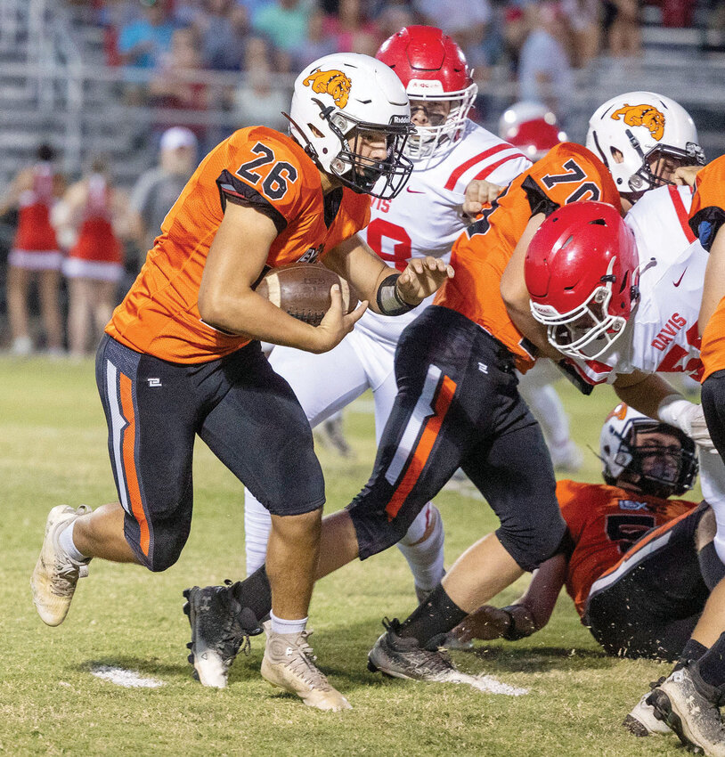 Lexington sophomore Cameron Weatherford fights for yards Friday night during the Bulldogs&rsquo; game against Davis. Lexington was defeated 53-0.