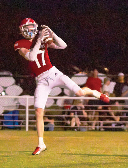 Washington senior Max Wilson hauls in a touchdown pass by senior Major Cantrell Friday night during the Warriors&rsquo; 51-0 win over CCS. Cantrell threw six touchdowns to five different wide receivers in the win.