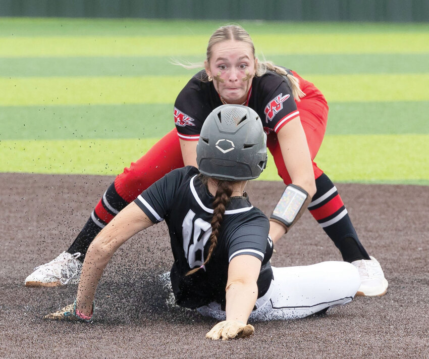 Washington junior Breanna Lindert slaps a tag on a Lone Grove base runner for an out in the semifinals of the State fast-pitch softball tournament. Washington fell 3-2.