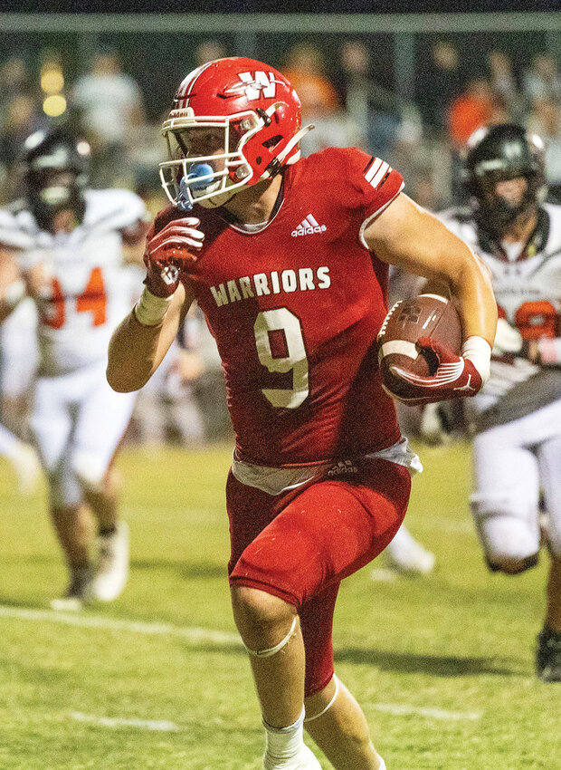 Washington junior Nate Roberts runs with the ball Thursday night during the Warriors&rsquo; 54-0 win over Lindsay. Roberts had four receptions for 57 yards in the game.