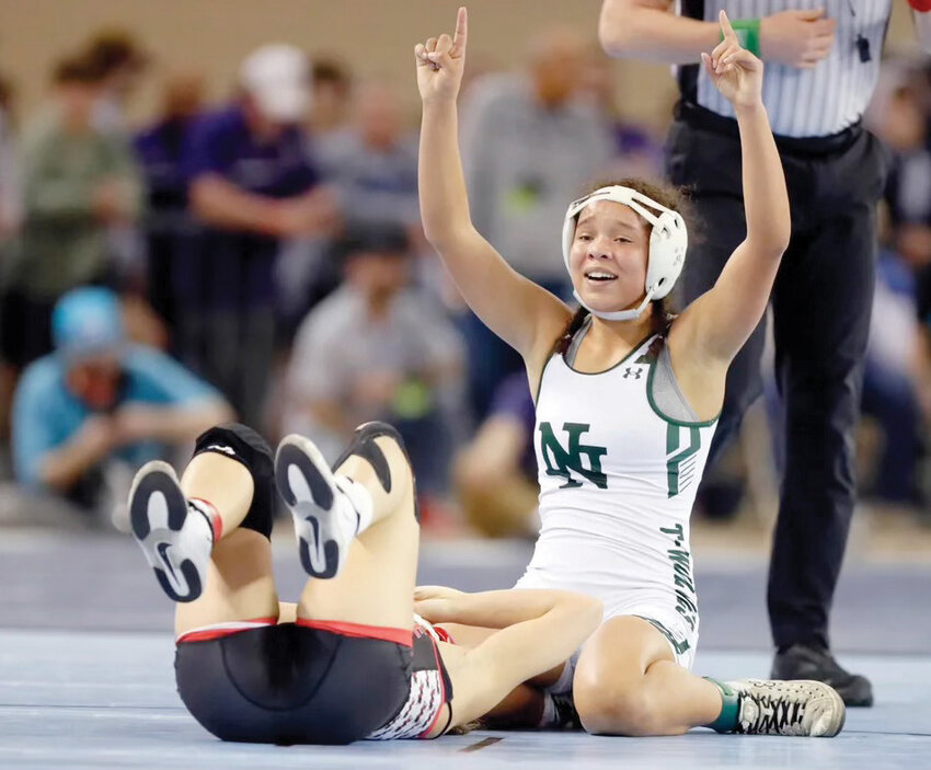 Norman North junior Coty Sessions signals where she finished in the 110 pound weight division of the OSSAA State Wrestling Meet last week in Oklahoma City.