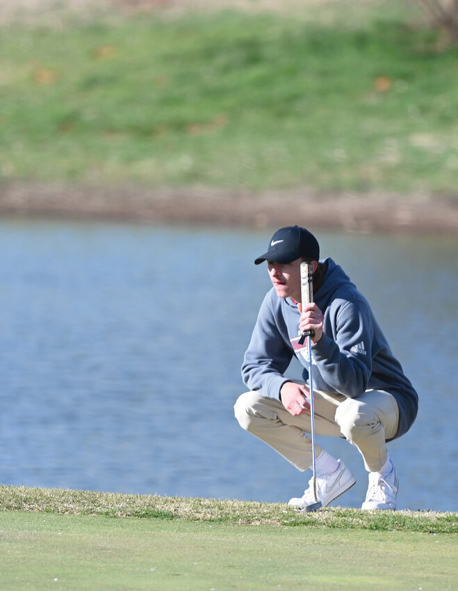 Purcell senior Colt Taylor studies the green before attempting a putt during the Purcell Invitational golf tournament at Brent Bruehl Golf Course. Taylor shot 106.