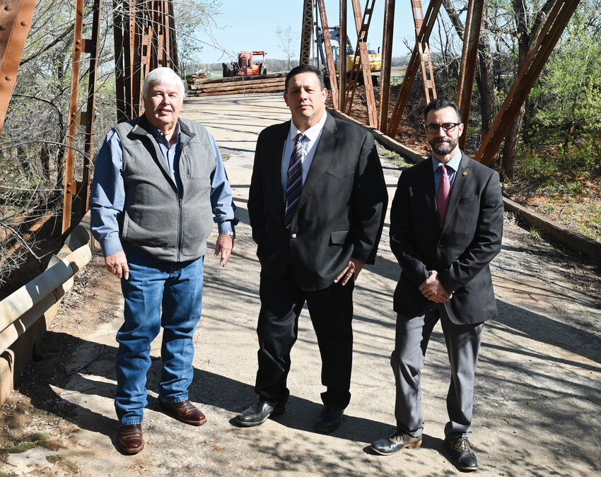 A new bridge will be constructed on the north edge of Washington to replace the now-closed full truss bridge, which has been in disrepair for years. The Chickasaw Nation will donate the money for the project, which will cost about $1 million. Pictured are, from left, McClain County District 2 Commissioner Wilson Lyles, Bo Ellis and Terry Holman. Ellis and Holman are with the Chickasaw Nation&rsquo;s Roads and Bridges Transportation Division.