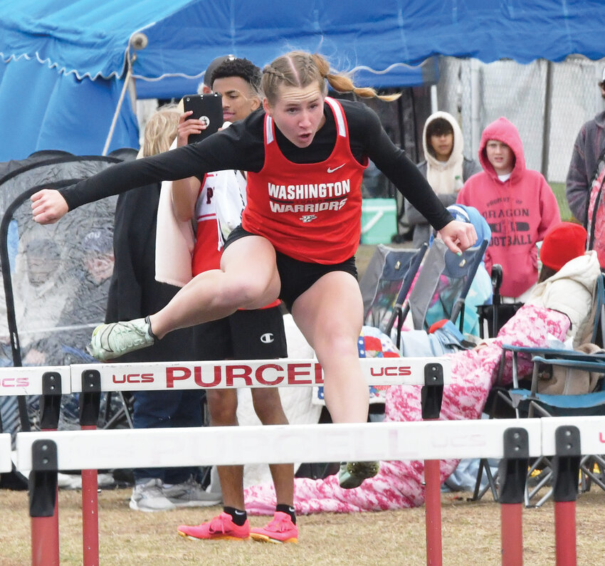 Washington junior Rielyn Scheffe runs the hurdles during the Purcell Invitational track meet April 2. Scheffe won both the 100 meter and 300 meter hurdles.