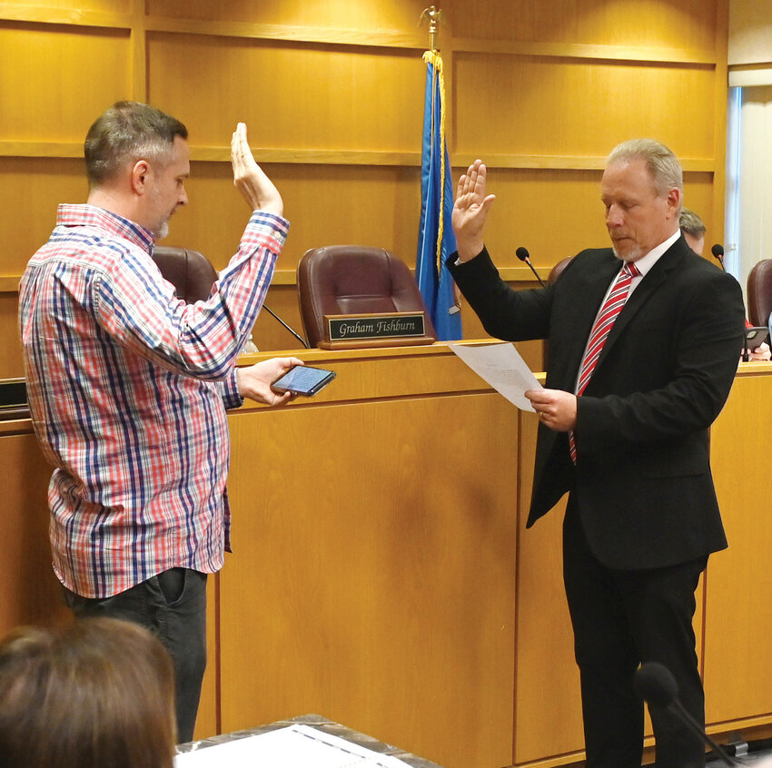 Purcell Mayor Graham Fishburn swore in new city councilman Greg Wheat (right) Monday night at the Purcell Police Service Building Community Room.