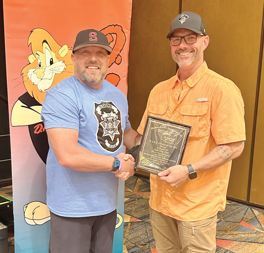 Purcell’s Sgt. Josh Van Oort, right, was honored last week in a ceremony in Durant as the Oklahoma D.A.R.E. Officers Association D.A.R.E. Officer of the Year. He was presented a plaque by association president James Richardson.