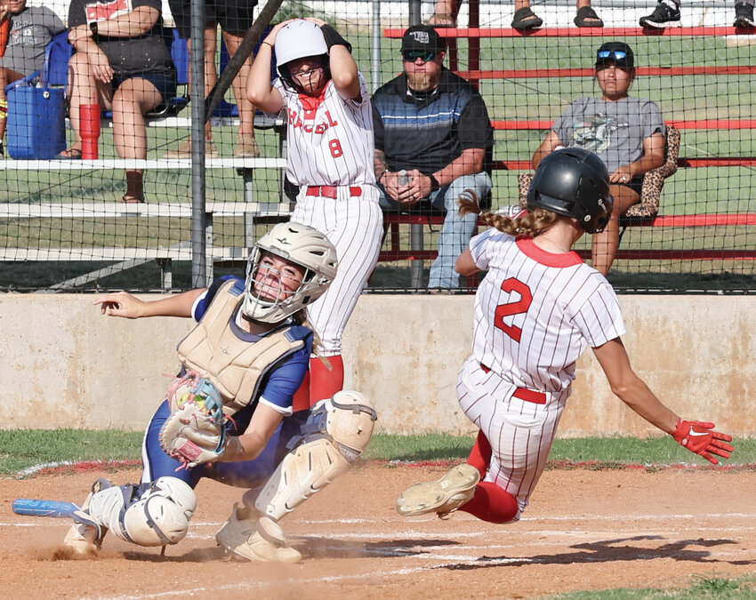 Purcell senior Hadleigh Harp (2) beats the throw home much to Hannah Whitaker&rsquo;s (8) amazement during the Dragons&rsquo; 16-1 win over Dickson.