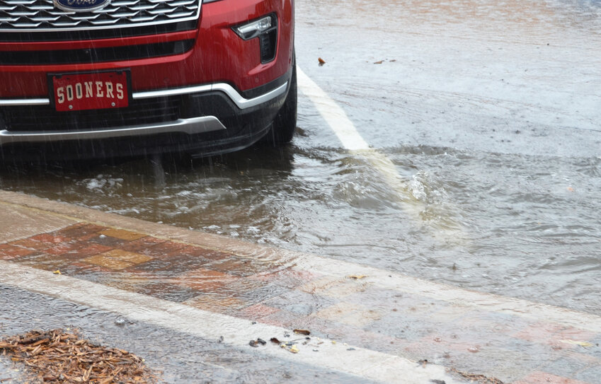 A deluge of rain in downtown Purcell Friday afternoon caused some minor flooding of Main Street. Water jumped the curb in front of The Purcell Register when an inch of rain fell.