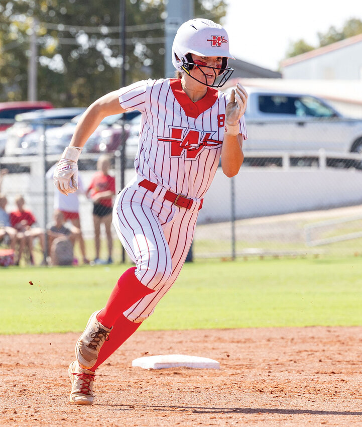 Washington sophomore Daphne Palumbo legs out a trip to third base during the Super Regional fast-pitch softball tournament. The Warriors defeated Sperry 3-0 and 8-0 to advance to the State tournament.