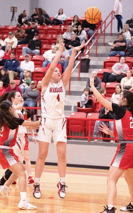 Washington senior Shelbie Caveness puts up a shot during the Warriors&rsquo; 68-41 win over Purcell. Caveness scored nine points in the game.
