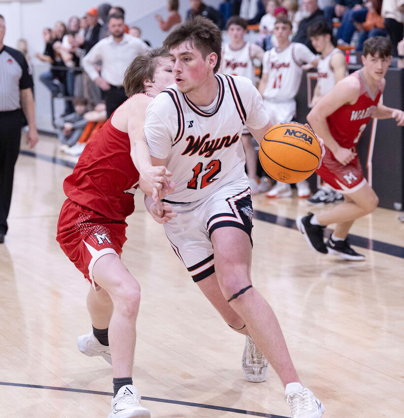 Wayne senior Ty Kemp beats a Maysville defender during their 67-35 win over the Warriors at home. Wayne is set to play Stonewall in the Regional tournament today (Thursday).