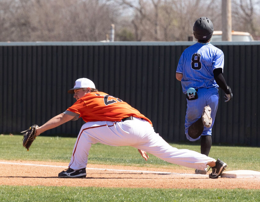 Lexington senior Ryan Johnson reaches for the ball at first base during Lexington&rsquo;s game against the OKC Mets. Lexington fell 24-1.