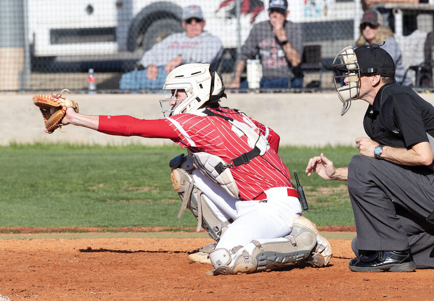 Parker Page, senior catcher for the Purcell Dragons, frames up a pitch in their contest with Tuttle. The Dragons lost the home match 12-3.