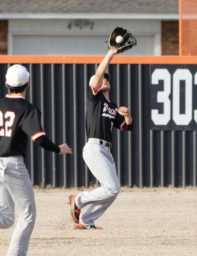 Wayne outfielder Duke Moore snags a pop fly in recent baseball action as Lane Lewis backs him up. The Bulldogs took home second place in the I-35 Classic after a loss to Purcell in the championship game.