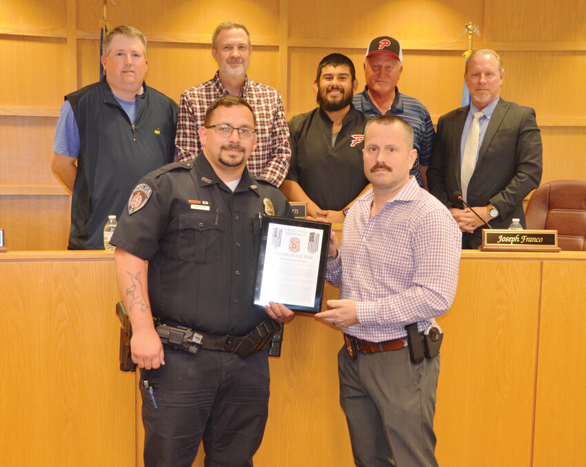 Joshua Miller was honored at Monday night&rsquo;s city council meeting as the 2024 Purcell Police Department&rsquo;s Officer of the Year by Assistant Chief James Bolling. In the background is the city council including Mayor Graham Fishburn and councilmen Jay Tate, Joseph Franco, Bobby Bruehl and Greg Wheat.