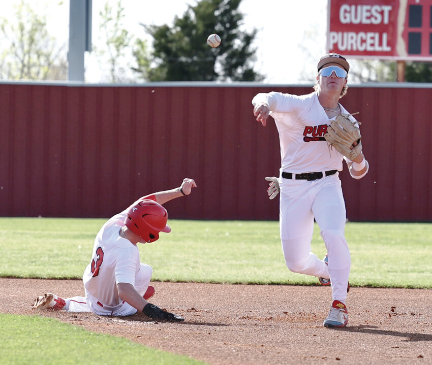 Purcell senior Boston Knowles turns a double play during the Dragons’ 10-0 win over Vanoss in the Heart of Oklahoma baseball tournament. Purcell took runners-up in the tournament.