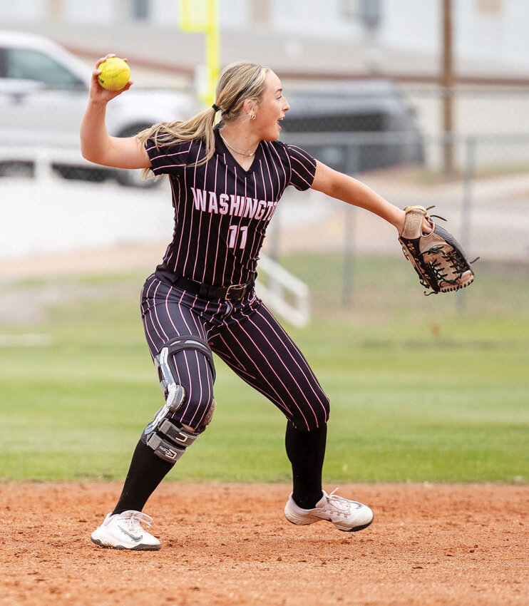 Washington junior Emersyn Massey fields a ball and throws for an out for the Warriors during their 19-1 win over Anadarko.