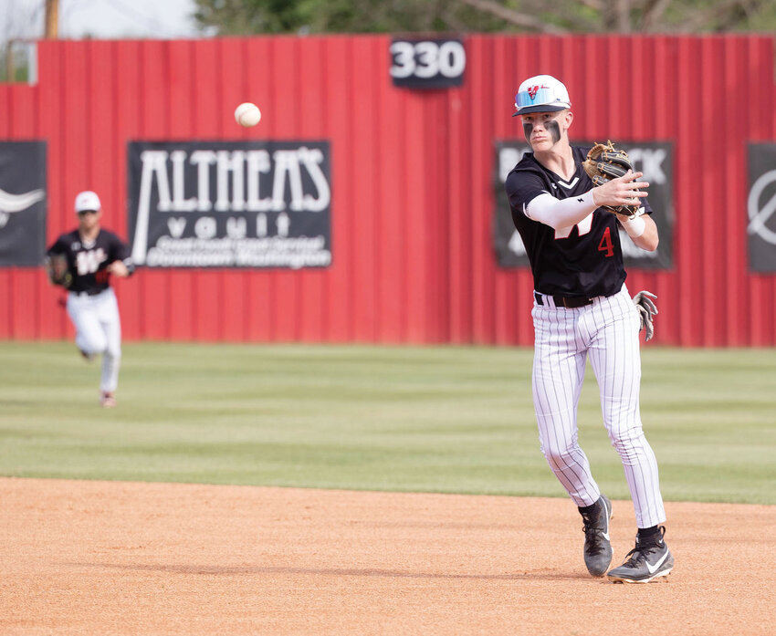 Washington freshman Jackson Mays makes a throw to first base for an out during the Warriors&rsquo; win over Casady. Washington won both District games, 10-0 and 15-0. Washington is 17-9 this season. Please see full story on page 3B.