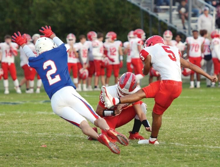 Cale Walker (5) gets off the point after attempt before a Christian Heritage defender can block the kick.