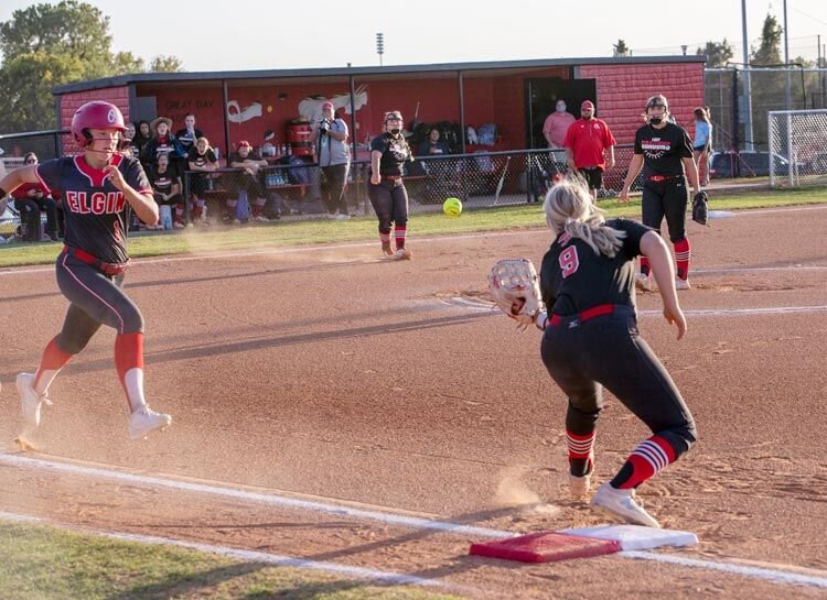 Hannah Buchanan throws to Dragon first baseman Kinley Croslin (9) while pitcher Brook Fleming looks on. Purcell defeated Elgin 14-2 and 21-19 to advance to the Regional tournament.
