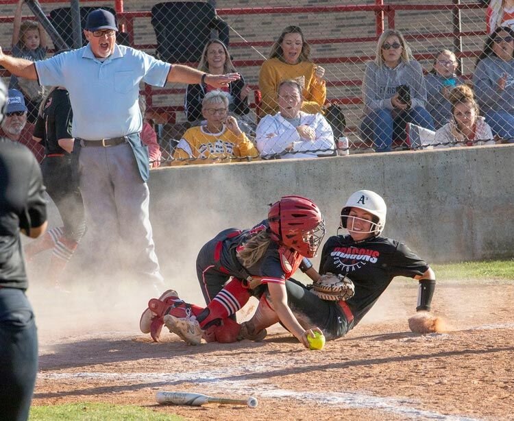 Brook Fleming safely slides into home after dislodging the ball from the catcher’s mitt during Purcell’s bi-District clash with Elgin. The Dragons lost the first game to the Owls 8-7 before coming back to win two games (14-2 and 21-19) to advance to Regionals.