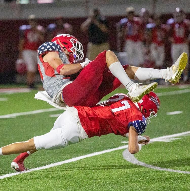 Dayton Smith (27) takes out the legs of Kade Norman Friday night at Conger Field. Washington defeated Purcell 40-27.