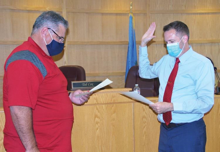 Mayor Ted Cox officially swore in Graham Fishburn for another term on the Purcell City Council Monday night at the Community Room of the Police Service Building.