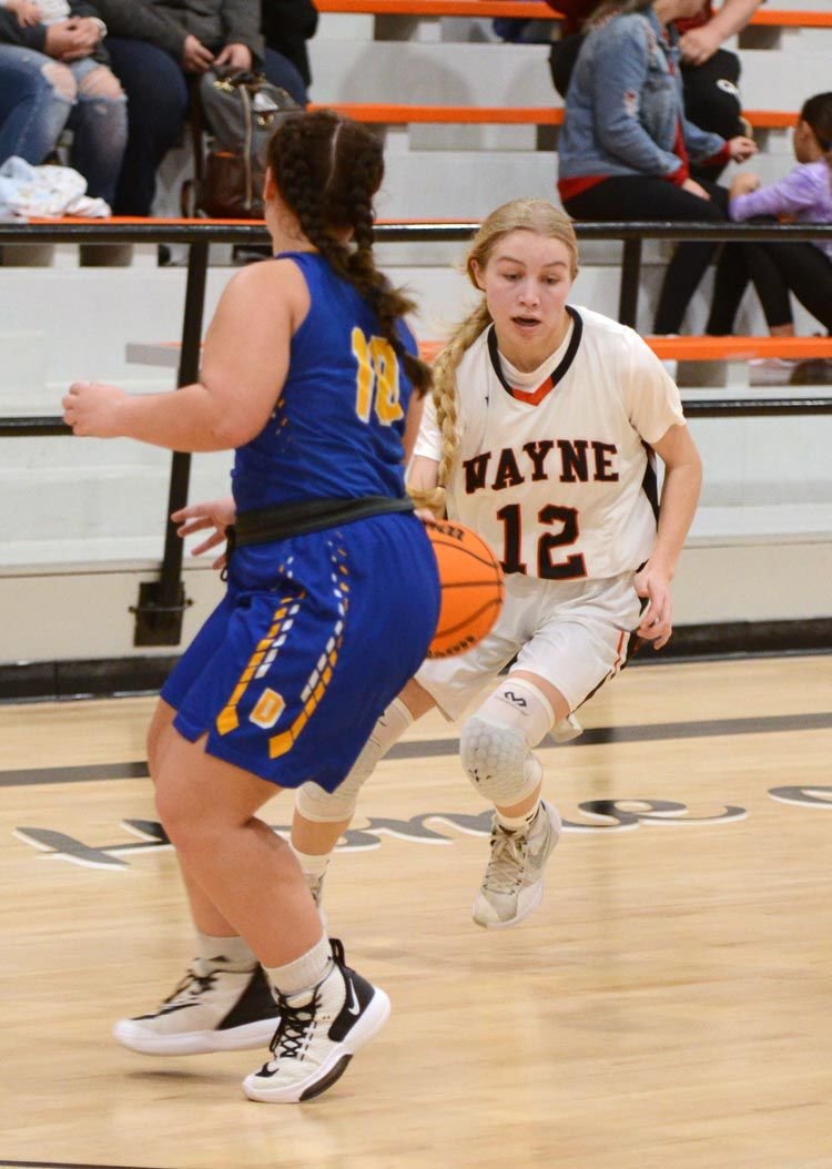 Allie Walck drives by a Dibble defender during Wayne’s 50-36 win over the Demons. Walck scored four points in the game.