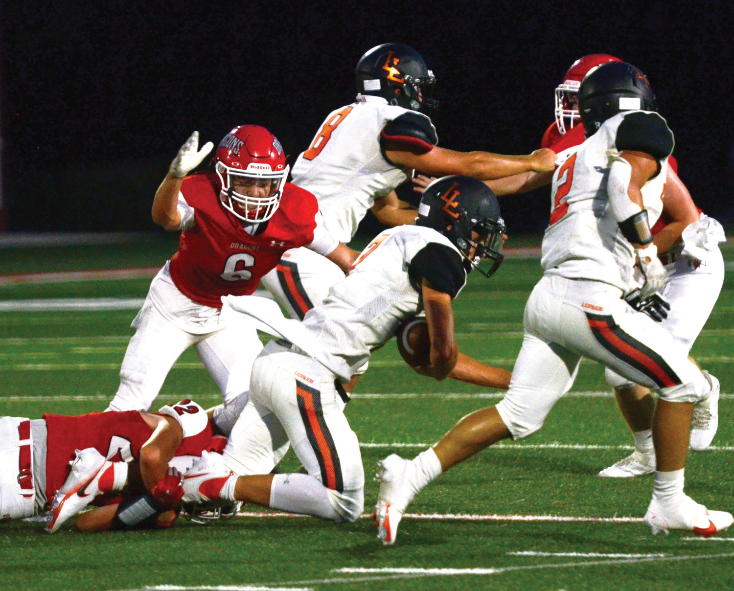 Purcell freshman Kash Guthmueller (6) goes airborn to finish off a Lindsay runner after Payson Purcell (22) grabbed his legs. The Dragons defeated the Leopards 20-14. They travel to Meeker Friday for a 7 p.m. kickoff.