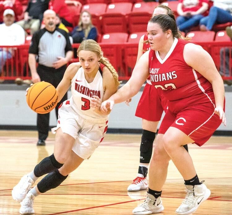 Washington junior Mattie Richardson drives around a Comanche defender during the Regional basketball tournament. The Warriors’ season ended in the Area tournament Friday after a 55-37 defeat by Marlow.