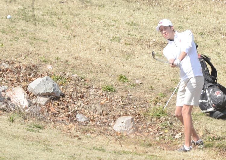 Washington senior Brody Moore plays a shot to the green from a tough lie on hole No. 4 at Brent Bruehl Memorial Golf Course Monday. Moore shot 90 in the tournament.