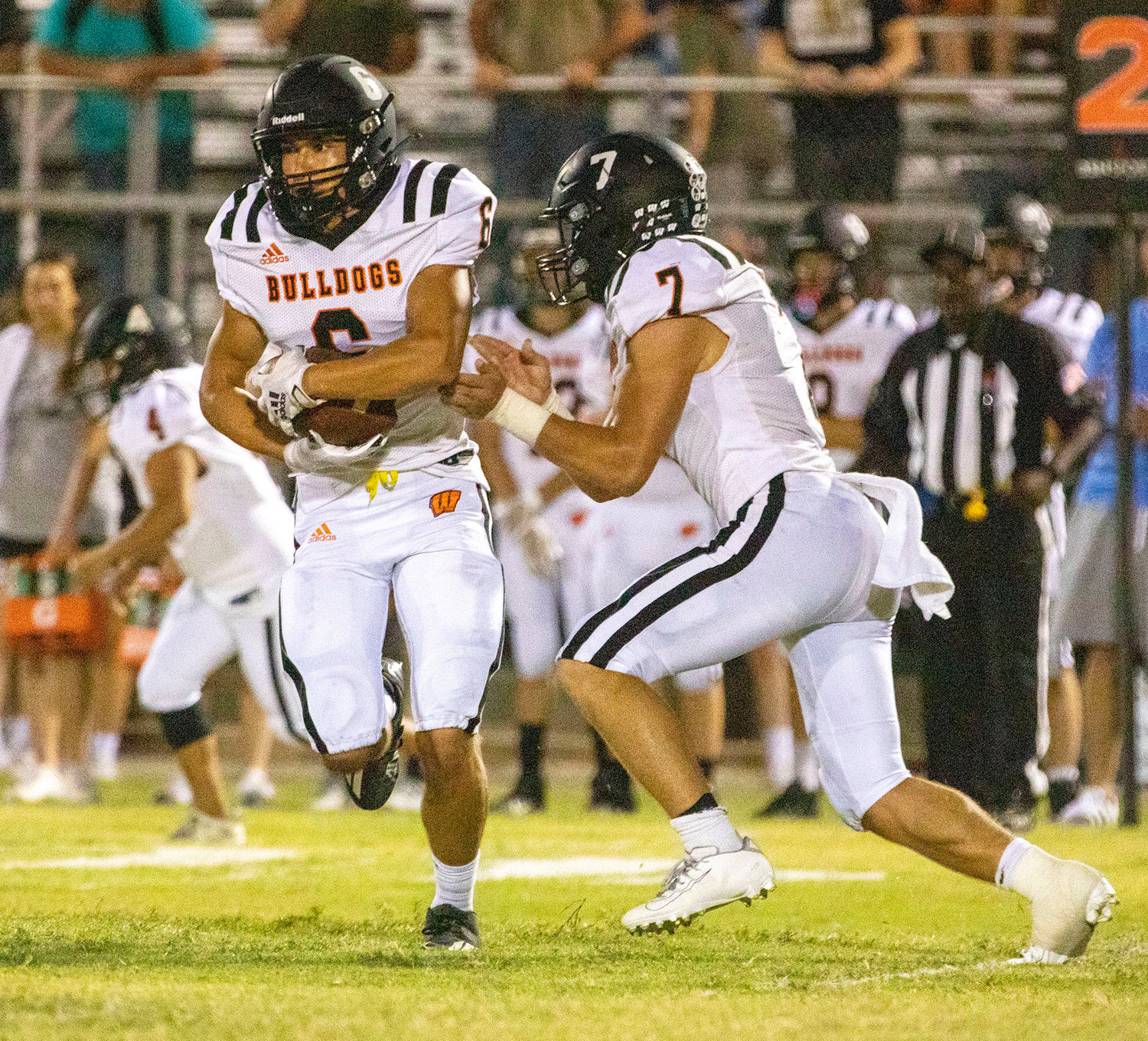 Wayne senior Jairo Hernandez takes a handoff from quarterback Ethan Mullins Friday night during Wayne’s 46-6 win over Lexington. Hernandez had four carries for 21 yards and a touchdown.