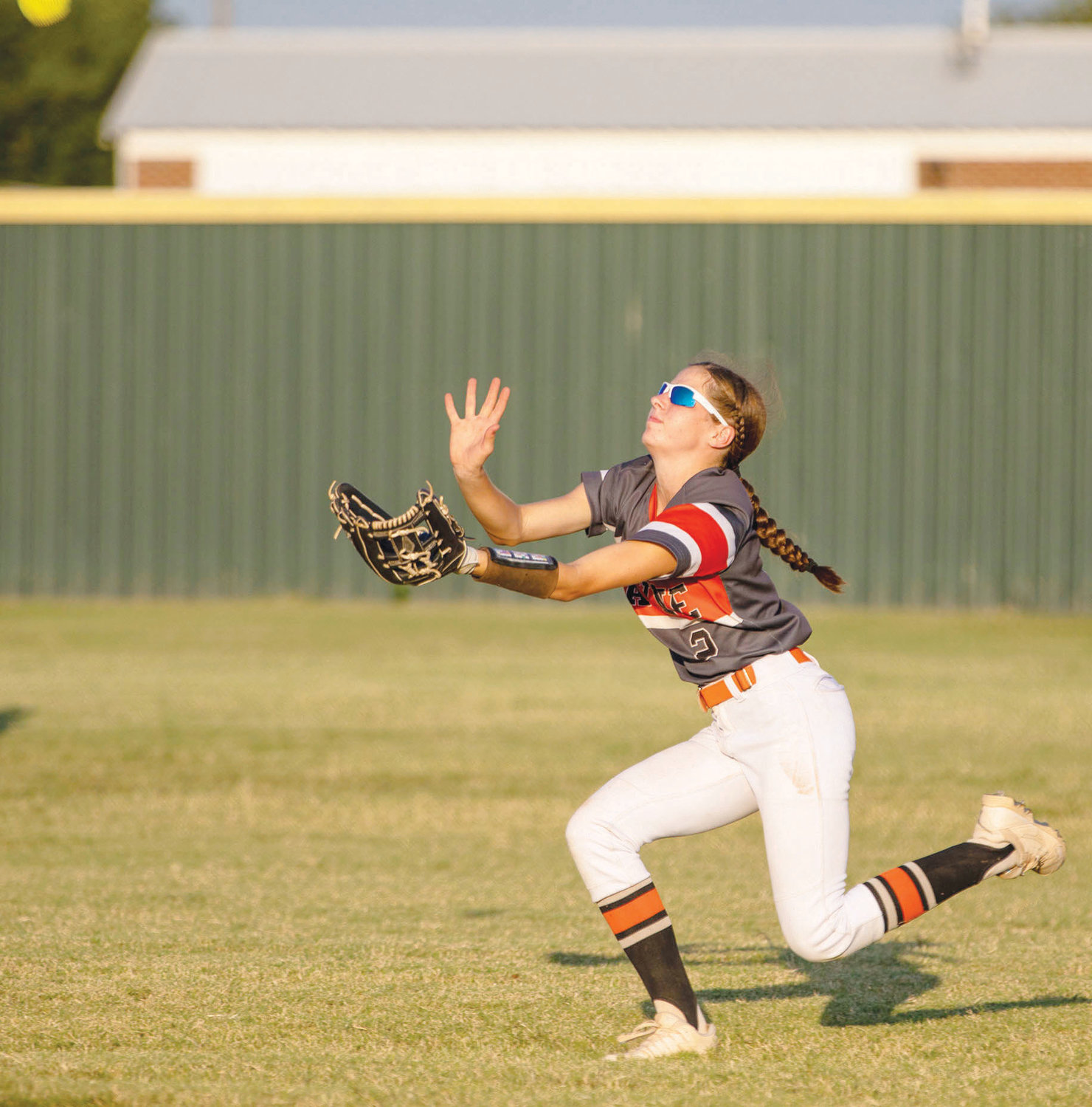 Wayne sophomore Haylee Durrence slides under a fly ball for an out Monday during the Bulldogs’ 9-2 win over Asher. Durrence made several plays for Wayne in the outfield in the game.