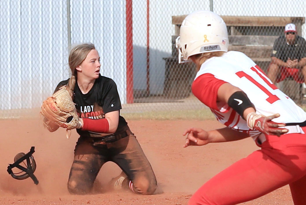 Purcell junior Lauren Holmes throws to second base for a double play after making a fantastic catch in the infield against Washington. The Dragons were defeated 9-0.
