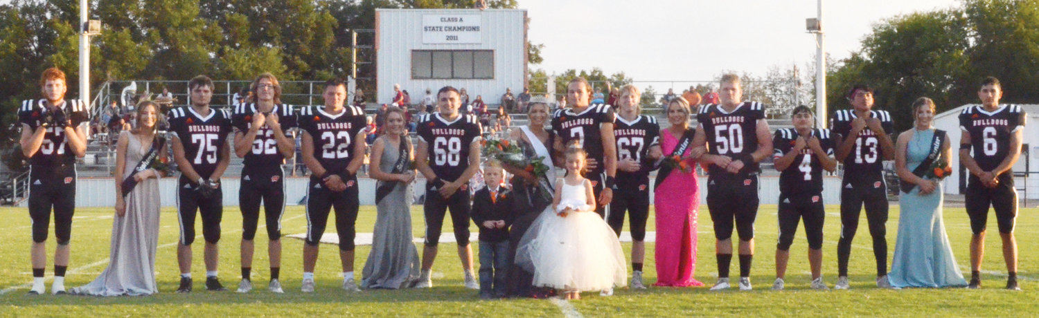 Homecoming festivities for Wayne were held Friday night at D.S. Zack Powell Stadium with the Bulldogs hosting Wynnewood. Pictured are, from left, Cody Davis, Haylee Durrence, Jerry Akins, Kevin Bynum, Brannon Lewelling, Mckenzie Fisher, Maddox Mantooth, Haiden Parker, Ethan Mullins, Kolten Miller, Hannah VanSchuyver, Andy Lee, Jr. Perez, Dom Sampson, Kaylee Madden, and Jairo Hernandez. Crown bearer Kash Evans and flower girl Addison Martin are in front.