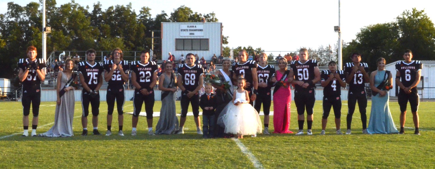 Homecoming festivities for Wayne were held Friday night at D.S. Zack Powell Stadium with the Bulldogs hosting Wynnewood. Pictured are, from left, Cody Davis, Haylee Durrence, Jerry Akins, Kevin Bynum, Brannon Lewellling, Mckenzie Fisher, Maddox Mantooth, Haiden Parker, Ethan Mullins, Braxton Smith, Hannah VanSchuyver, Andy Lee, Jr. Perez, Dom Sampson, Kaylee Madden, and Jairo Hernandez. Crown bearer Kash Evans and flower girl Addison Martin are in front.