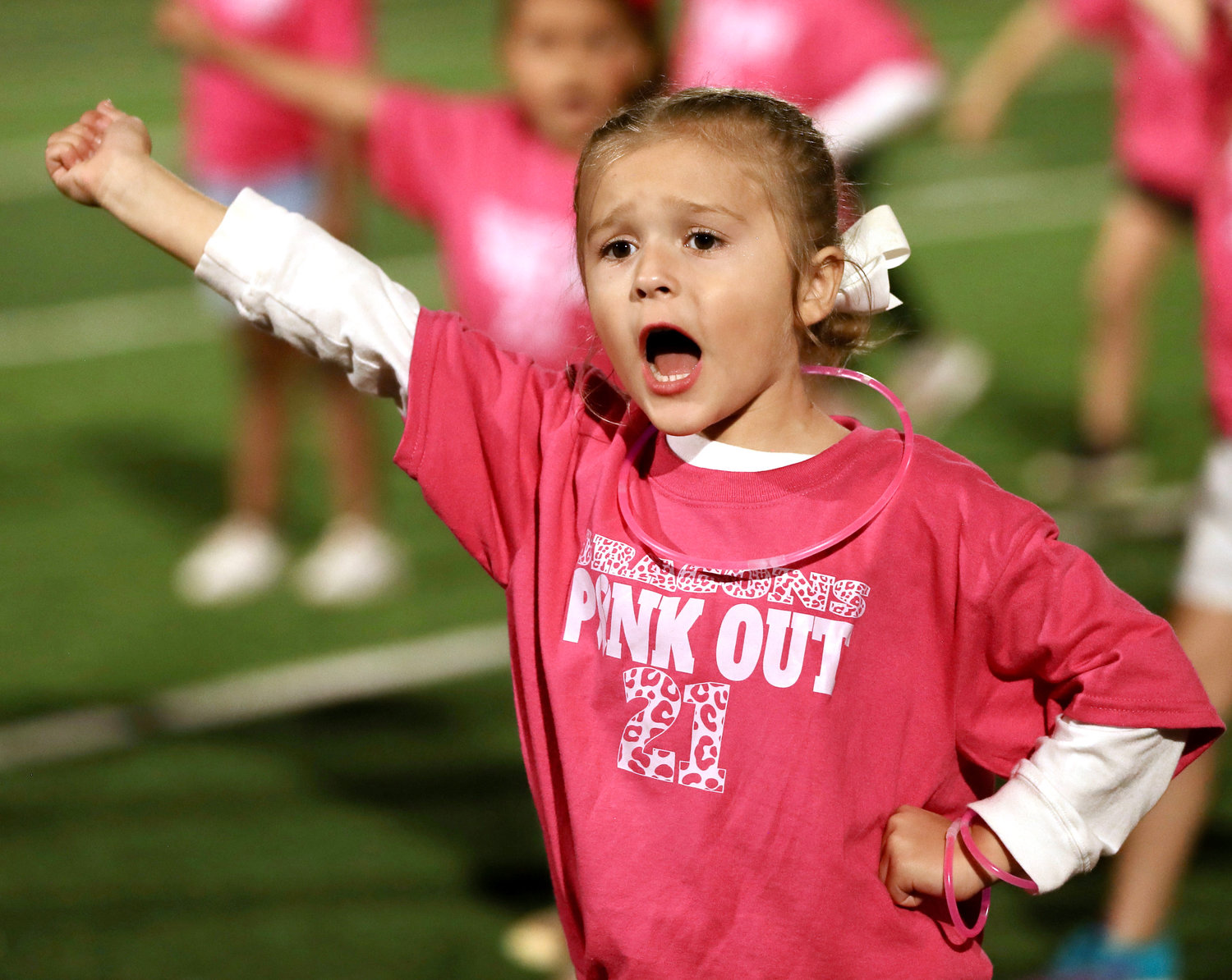 Mikiah McAnally cheers at halftime of Thursday night’s Purcell football game during the Dragon cheer camp routine.