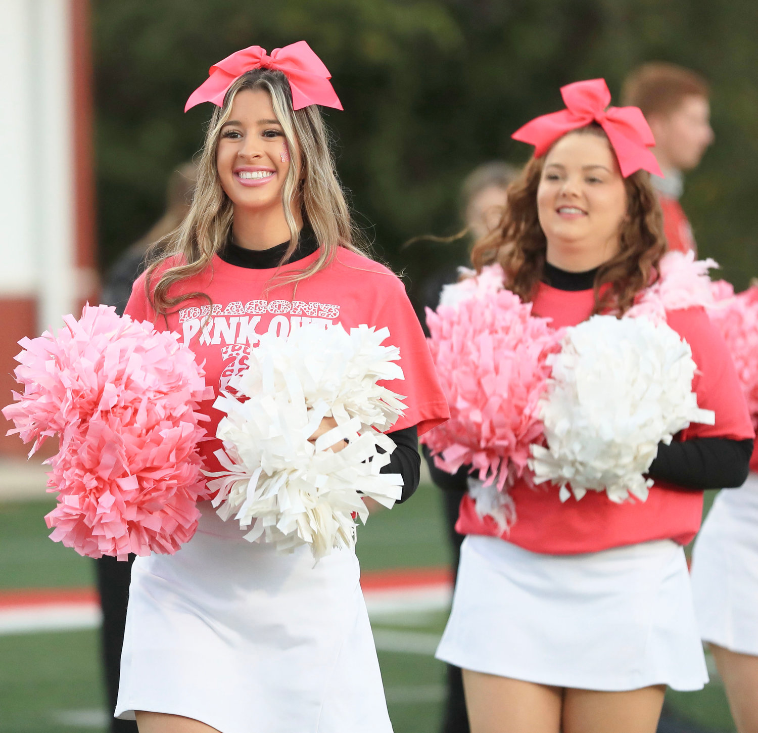 Kaylee Stephens and Avery Wren cheered on the Dragons at last Thursday’s Pink Out game against Crooked Oak.