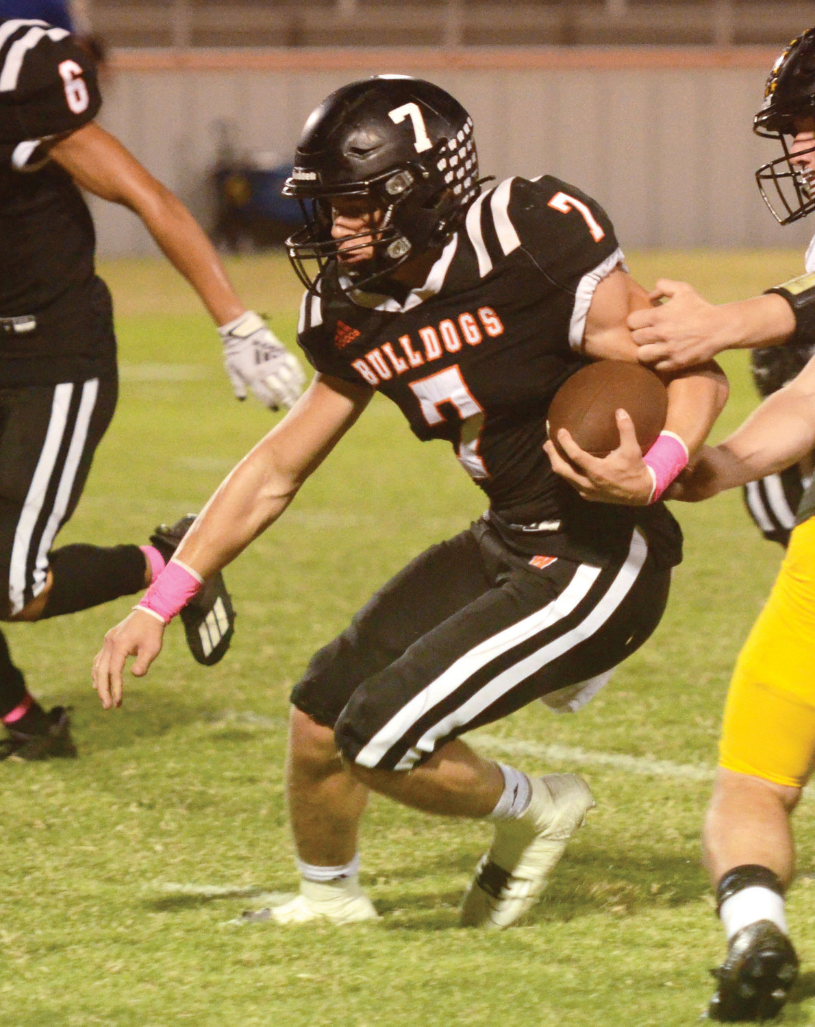 Wayne senior Ethan Mullins carries the ball for some of his 230 rushing yards Thursday night during the Bulldogs’ 51-0 win over the Demons. Mullins also threw for 129 yards and finished the night with seven touchdowns.