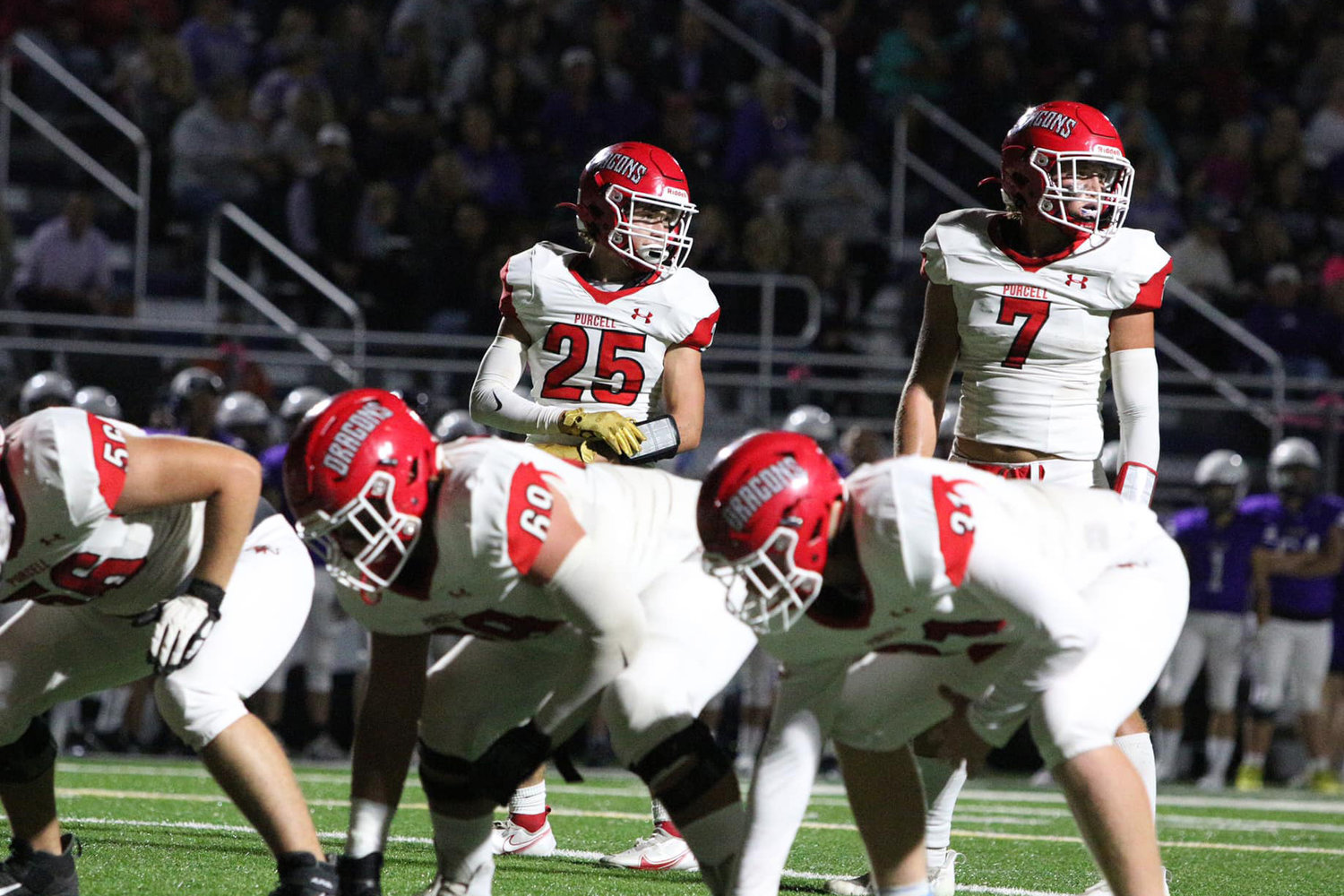 Boston Knowles (25) and Creed Smith (7) look to the sidelines behind Jace Clary (56), Brendan Bacon (69) and Brody Holder (31) during last week’s game against CCS. The Dragons lost to the Royals 38-17 and host Lexington in the Battle for the Bridge Friday night at 7 p.m.