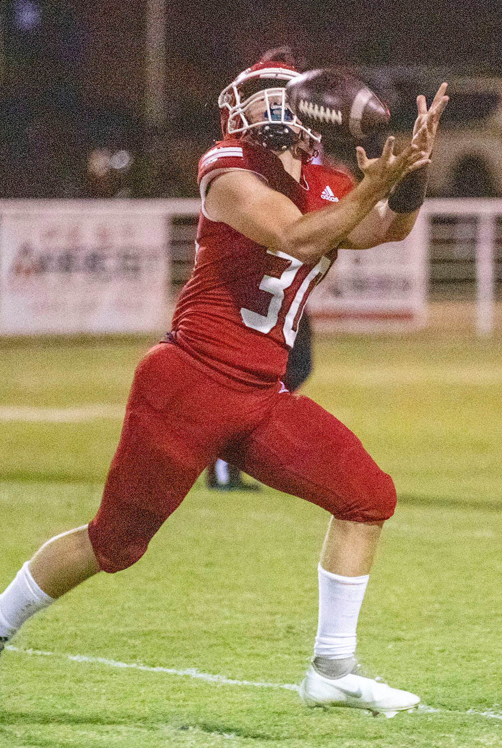 Washington sophomore Kade Norman hauls in a touchdown pass Friday night during the Warriors’ 69-0 win over Holdenville.