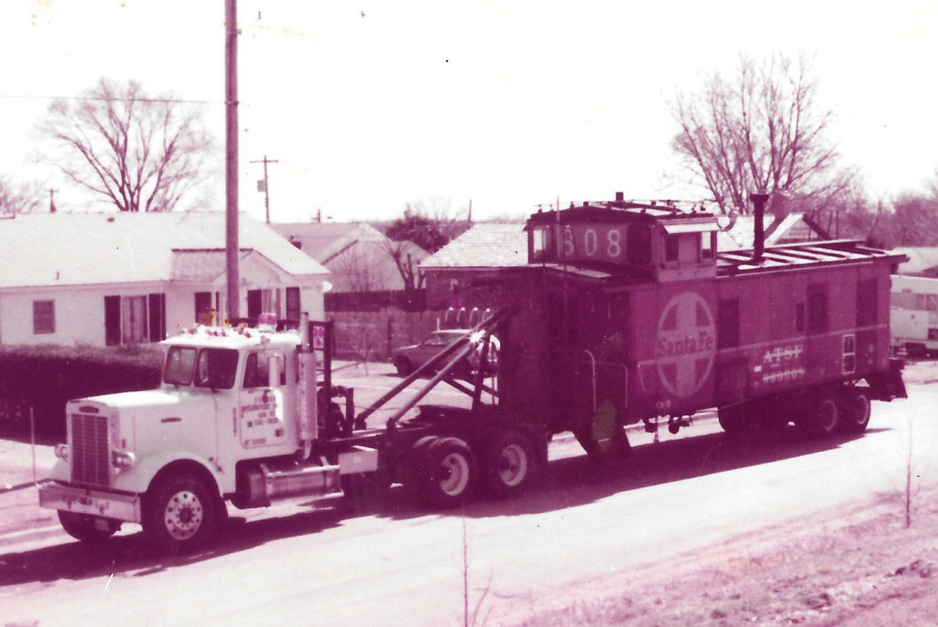 Sam Harlan hired a house mover to relocate the caboose from his yard to the park at 2nd and Main in downtown Purcell.